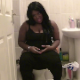 A big, black British girl speaks to us and takes a shit while sitting on a toilet. Subtle, but audible poop sounds. She wipes her ass, shows us her dirty toilet paper, then finally spreads her ass cheeks. About 3.5 minutes